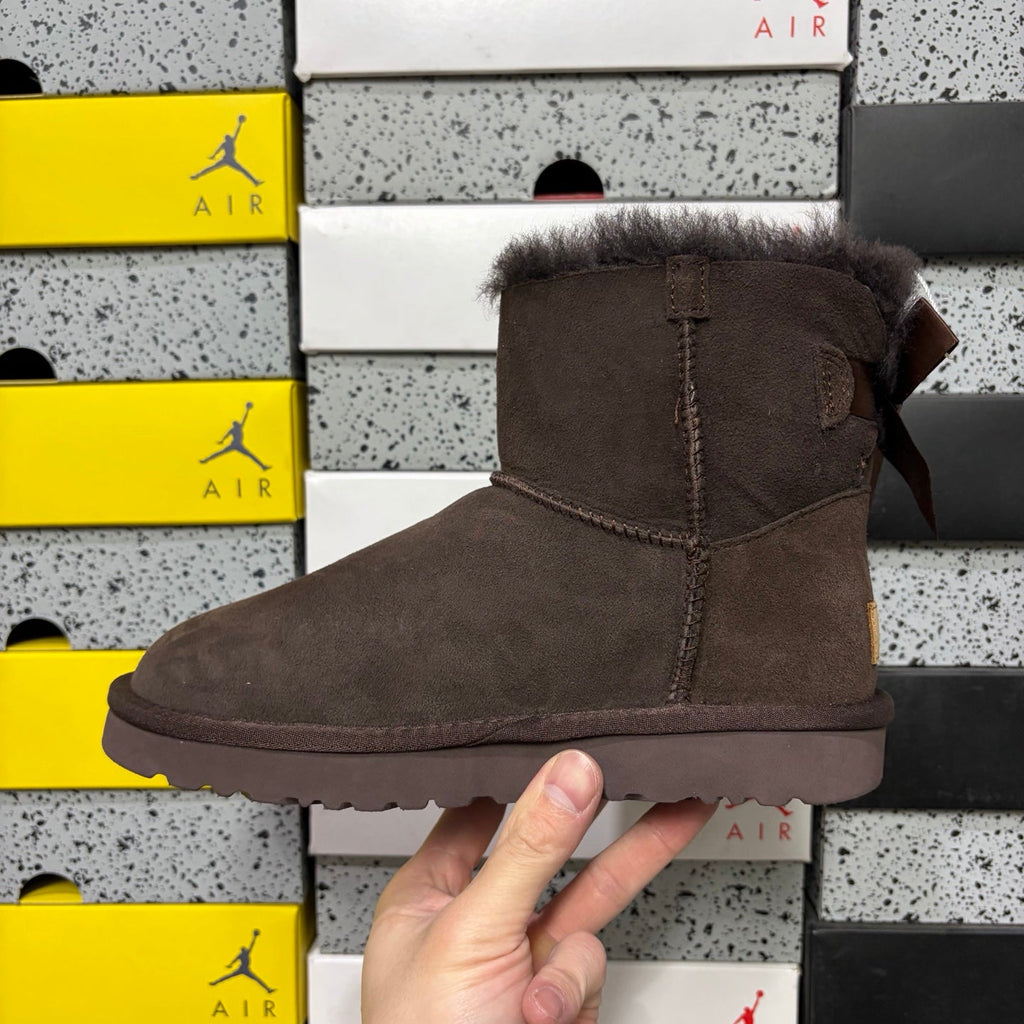 UGG Mini Bailey Bow Ankle Boot – Suede Boot with Tonal Dark Shearling Lining, Chocolate Satin Bow & Dark Sugar Sole in Chocolate